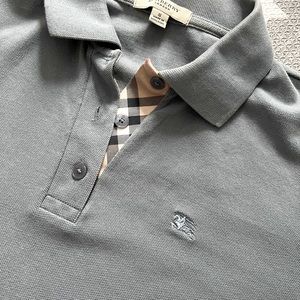 Used gray-blue polo short sleeved shirt in size small.